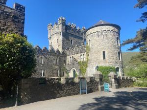 an old castle with a tower on top of it at Cope House Rooms in Killybegs