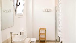 a white bathroom with a sink and a mirror at Villa Guvalmar Chalet Roche in Roche
