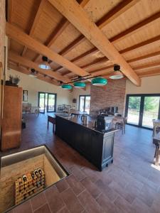 a large room with a bar with a bunch of wine bottles at Ca' Sinoira in Nizza Monferrato
