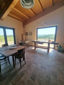 a dining room with a table and a large window at Ca' Sinoira in Nizza Monferrato +20 photos