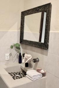 a bathroom with a sink with a mirror and towels at Chuk-Kay by ÓOL Hotels in Holbox Island +79 photos