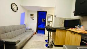 a living room with a couch and a blue door at Phoenix Garden Apartments - 4 - in Athens +12 photos