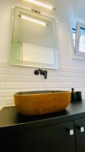 a bathroom with a wooden sink and a mirror at Phoenix Garden Apartments - 4 - in Athens
