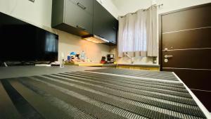 a kitchen with black cabinets and a black floor at Phoenix Garden Apartments - 4 - in Athens