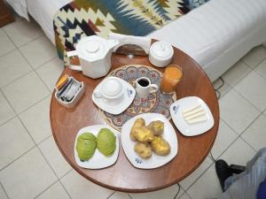 a wooden table with plates of food on it at Hotel INTERnazionale in Ayacucho +30 photos