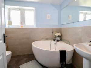 a bathroom with a tub and a sink and a toilet at The Dacha in Winchester +37 photos