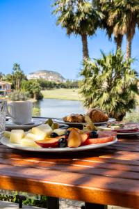 a plate of food sitting on a wooden table at Hotel Alicante Golf in Alicante