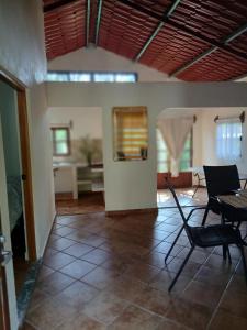 a living room with a table and chairs in it at PETIT PARADIS CABAÑA Catemaco Rainforest Nature in Catemaco