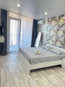 a bedroom with a bed and a chair at 2 минуты до моря in Batumi