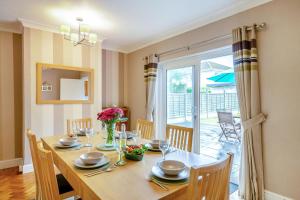 a dining room with a table with chairs and a window at 3 Bed in Seaton oc-mbdal in Seaton +23 photos