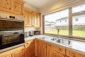 a kitchen with a sink and a large window at 3 Bed in Seaton oc-mbdal in Seaton
