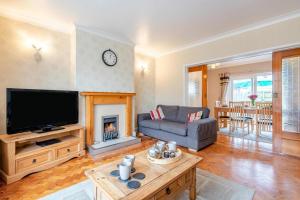 a living room with a couch and a fireplace at 3 Bed in Seaton oc-mbdal in Seaton