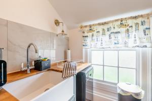 a kitchen with a large sink and a window at 1 Bed in Elstronwick oc-e42580 in Burton Pidsea +18 photos