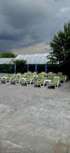 a row of lawn chairs sitting in a parking lot at Complexul Profestur in Valea Dragului