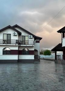 a white building with a balcony on the side of it at Complexul Profestur in Valea Dragului +97 photos