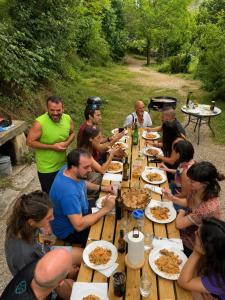 a group of people sitting around a wooden table eating food at Hogar del Sol in Pamplona