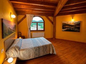 a bedroom with a bed and a window at Hogar del Sol in Pamplona +13 photos