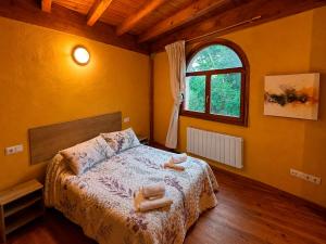 a bedroom with a bed with two towels on it at Hogar del Sol in Pamplona