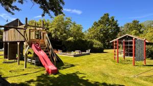 a playground with a slide and a play structure at Ferienhof-Wohler-Wohnung-5 in Bojendorf