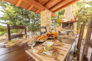 a table with plates of food on top of a table at Villa Cassandra in Alliste