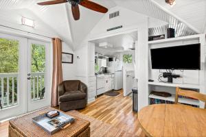a living room with a tv and a table at Margarita Days in Seagrove Beach