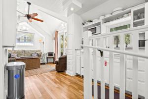 a living room with white walls and a ceiling fan at Margarita Days in Seagrove Beach +24 photos