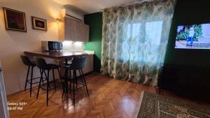 a kitchen with a table and chairs and a window at Trogir apartments in Trogir