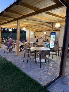a group of people sitting at tables under a pavilion at Transylvania WINE in Turda