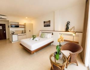 a bedroom with a bed and a table and a chair at Tropical Keys in Paramaribo