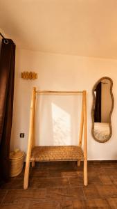 a wooden bench in a room with a mirror at Thayri Hostel - Sea View in Sidi Kaouki +46 photos