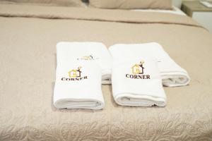 a group of towels sitting on top of a bed at Corner Apartments in Tirana +102 photos