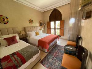 a bedroom with two beds and a window at Villa Bouchra in Marrakesh +54 photos
