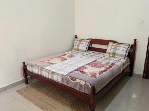 a bed with two pillows on it in a room at Amare Guest House in Cyuve