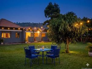 a table and chairs in a yard at night at Amare Guest House in Cyuve