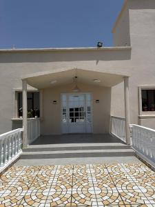 a front porch of a house with a door at فيلا الريف in Kusāt