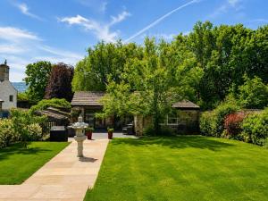 a house with a yard with a grassy lawn at The Summerhouse in Keighley