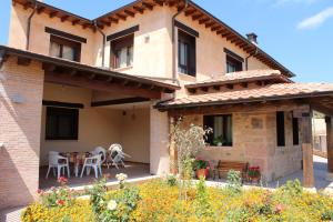 a house with a patio and a table and chairs at El Mirador de Alcuneza in Sigüenza