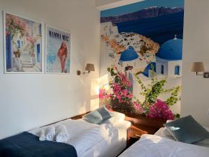 a bedroom with two beds and a mural on the wall at La Melodia in Kościerzyna