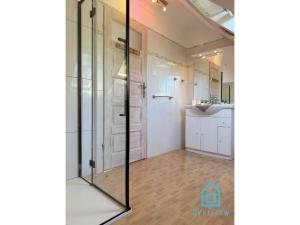 a bathroom with a glass shower and a sink at NaWypasie Grand Apartment with Fireplace Beautiful Garden SUP Board and Just 30 Minutes from Gdańsk and Gdynia in Szemud +34 photos