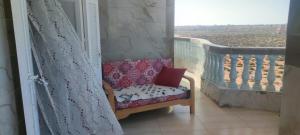 a chair sitting on a balcony with a window at Zaytouna camp Room 2 in Marsa Matruh