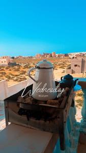 a tea kettle sitting on a table with a view of a desert at Zaytouna camp Room 2 in Marsa Matruh