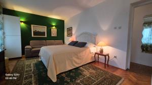 a bedroom with a bed and a couch at Trogir apartments in Trogir
