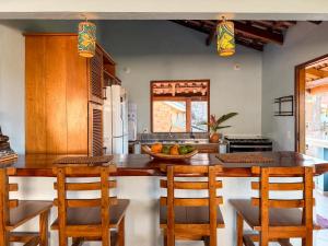 a kitchen with a large wooden table and chairs at Casa Magna in Itacaré