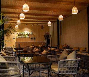 a restaurant with tables and chairs and lights at Saraiville- A Boutique Riverside Resort in Dehradun