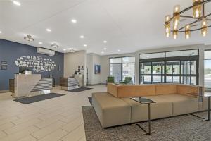 a lobby with a large couch and a table at Best Western Plus Marquette Hotel & Suites in Marquette