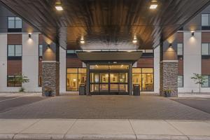 an entrance to a building with glass doors at Best Western Plus Marquette Hotel & Suites in Marquette