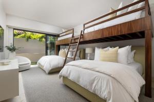 a bedroom with two bunk beds and a desk at Porta Fortuna Villa Punta Mita Gates in Punta Mita +20 photos