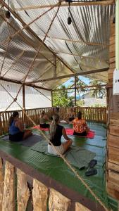 a group of people sitting on the floor in a tent at Holabay Surf Hostel in Arugam Bay