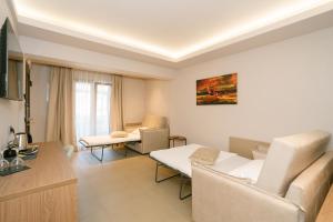 a living room with a couch and a table at Filakas in Syvota