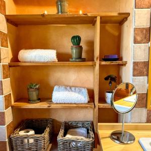 a shelf with baskets and a mirror on a table at Nerbone Farm Retreat in Perugia +70 photos